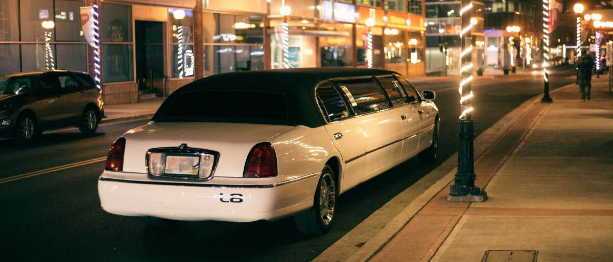 A Town Car limo parked in a downtown area